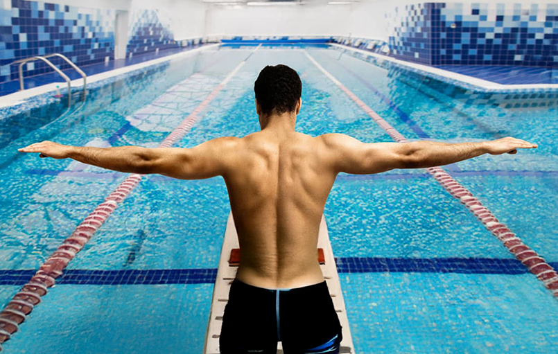 Person getting ready to dive into a pool
