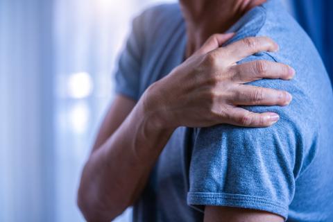 Man holding shoulder in pain