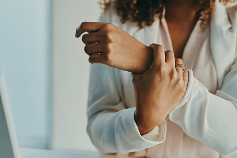 Woman holding painful wrist