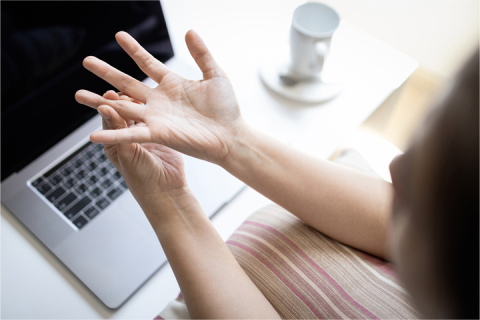 Woman holding painful finger