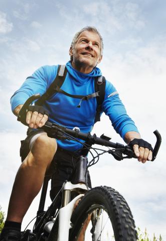 Older man riding mountain bike